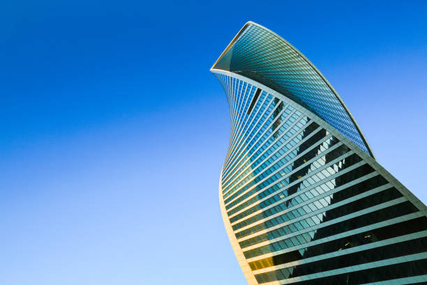 Skyscraper on blue sky. Skyscraper exterior design. Modern office building with glass facade in blue sky. Neo-futuristic architectural style. Urban view, looking up, skyline. Moscow city. Business Center. skyscraper stock pictures, royalty-free photos & images