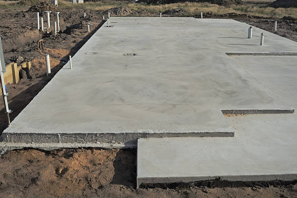 Slabs of concrete foundation for a building Concrete slab prepared for residential house construction with utility pipes within slab block shape stock pictures, royalty-free photos & images