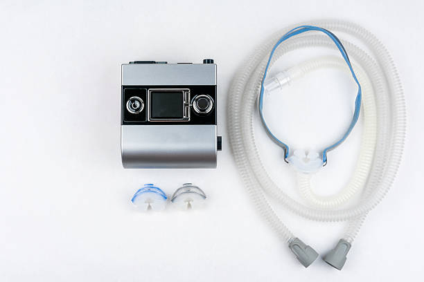 Sleep apnea treatment. CPAP machine with hose and mask. stock photo