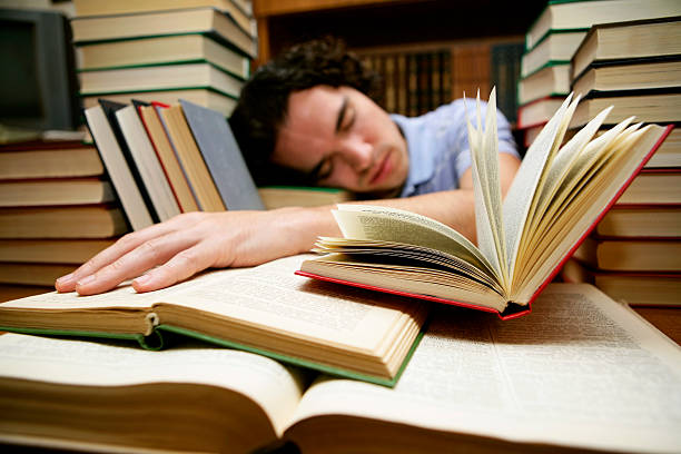 sleeping at the library - student night study stressed stockfoto's en -beelden