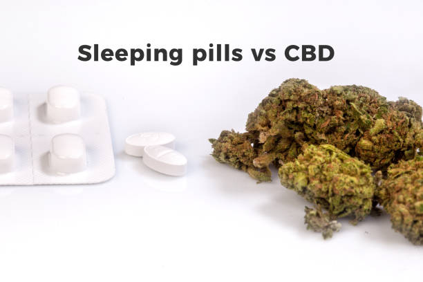 Sleeping pills VS CBD flowers stock photo