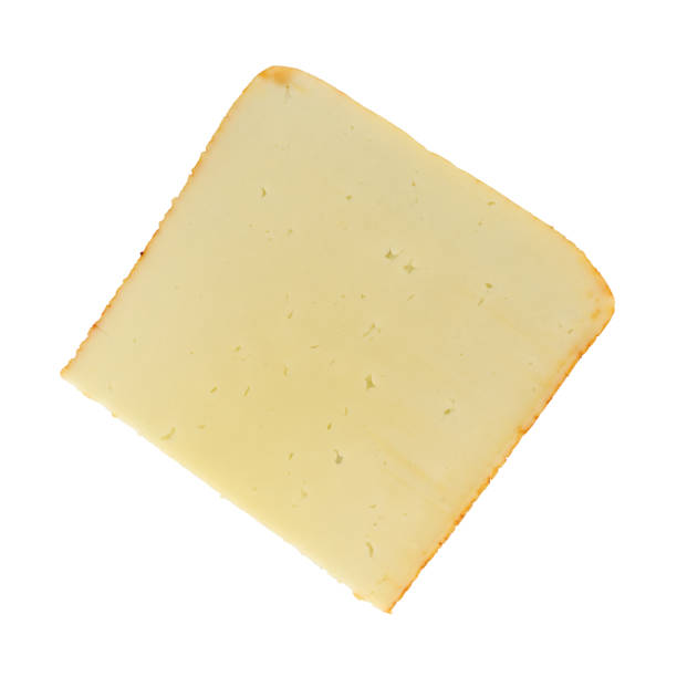 Slice of muenster cheese on a white background Top view of a single slice of muenster cheese isolated on a white background. muenster cheese stock pictures, royalty-free photos & images