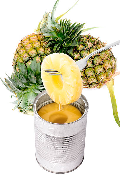 Slice of pineapple on a fork isolated stock photo