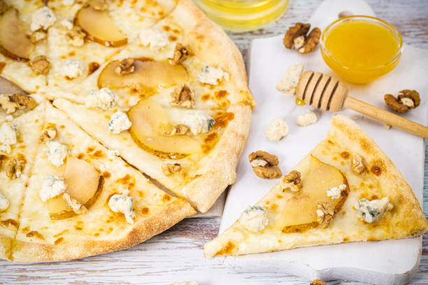 slice of pizza and blue cheese, caramelized pear and honey stock photo