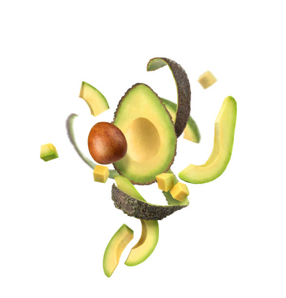gesneden avocado op een witte achtergrond met avocadoschil in de lucht - avocado stockfoto's en -beelden