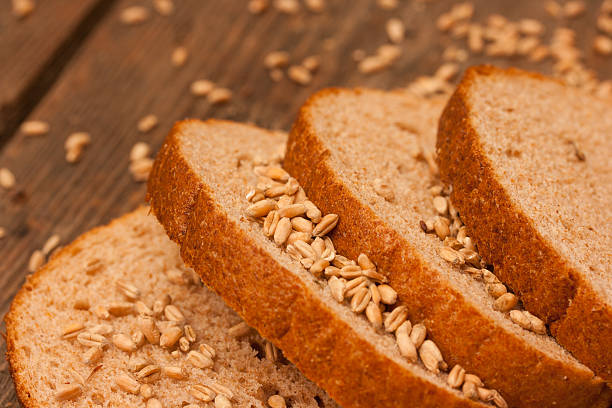 Sliced bread and wheat grains stock photo
