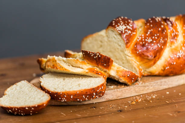 Sliced fresh challah bread on the wood table. stock photo