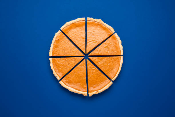 sliced pumpkin pie top view isolated on classic blue background. homemade cake. - serving a slice of cake imagens e fotografias de stock