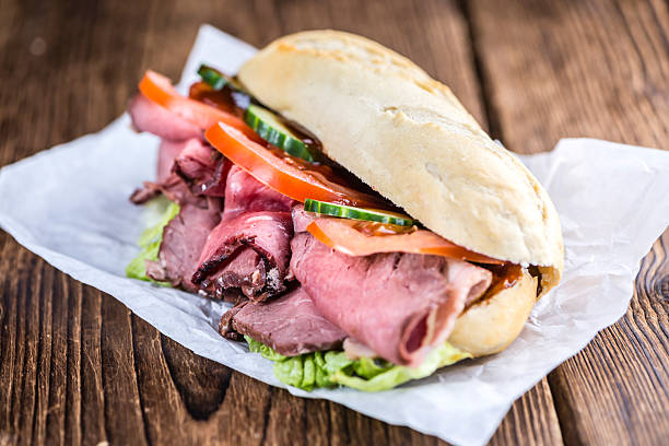 Sliced Roast Beef on a sandwich Sliced Roast Beef on a sandwich (selective focus; close-up shot) roast beef sandwich stock pictures, royalty-free photos & images