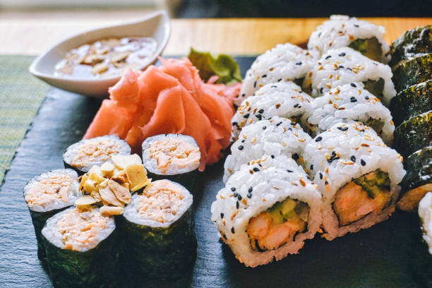 Sliced rolls of salmon sushi - set stock photo