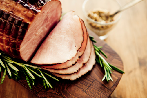 Smoked ham with rosemary and mustard. Selective focus.