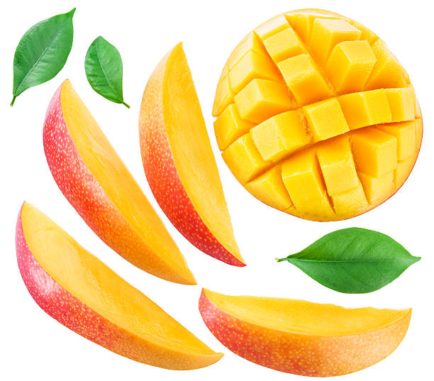 Slices of mango fruit and leaves over white. stock photo