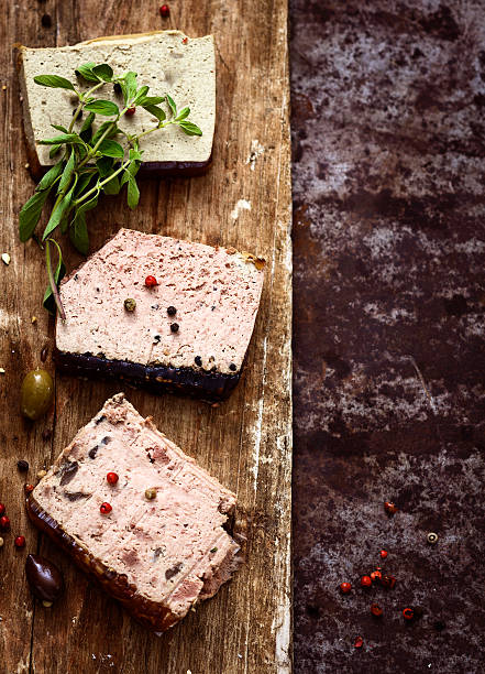 Slices of Pate Three kind of Pate (Port Wine, Cracked Pepper and Mushroom) over wooden surface. pate stock pictures, royalty-free photos & images