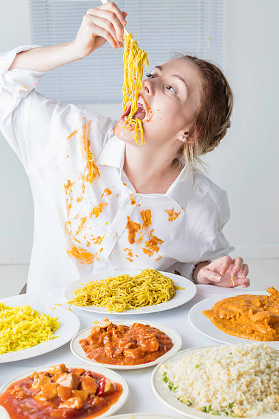 Slim Teenage Glutton Eating A Massive Meal stock photo