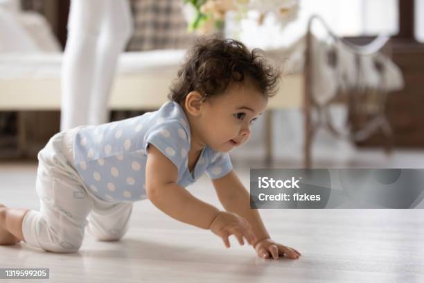 Small African American toddler crawl at home