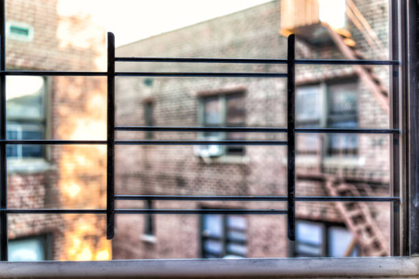 small apartment window in new york city nyc urban bronx, brooklyn brick housing, guard rail, security bars, grunge poverty - window, inside apartment, new york imagens e fotografias de stock