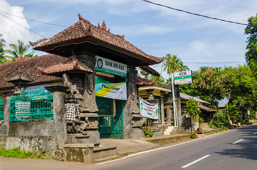 Tajakula, Bali Indonesia - March 28, 2013: A small branch of the BPD Bank in Bali Indonesia. This village is Tejakula in the north of Bali. The houses are small, near by the road and with a lot of distance between eachother. 