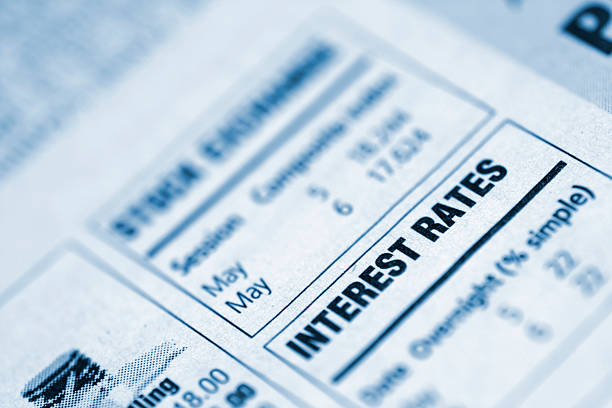 Small box in a newspaper containing interest rates info Closeup of "interest rates" text in a newspaper interest rate stock pictures, royalty-free photos & images