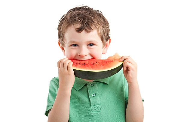 small boy eating watermelon stock photo