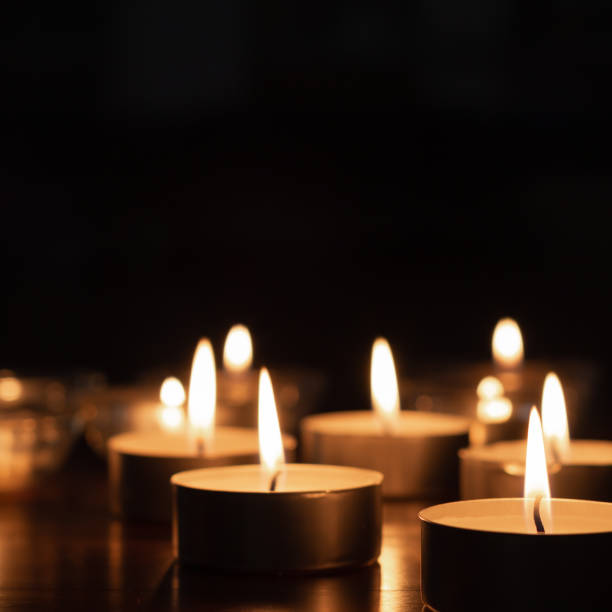 small candles burning in the dark stock photo