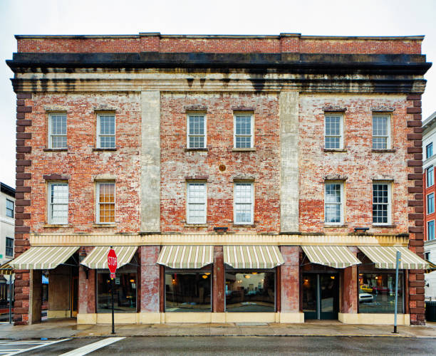 Small colonial brick building Small colonial brick building with a store on the first floor and apartments above awning window stock pictures, royalty-free photos & images