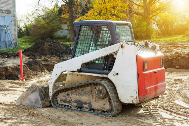small excavatot at construction site Mini excavator bobcat standing at construction site bobcat stock pictures, royalty-free photos & images