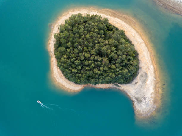 A small island A small island in the middle of lake. island stock pictures, royalty-free photos & images