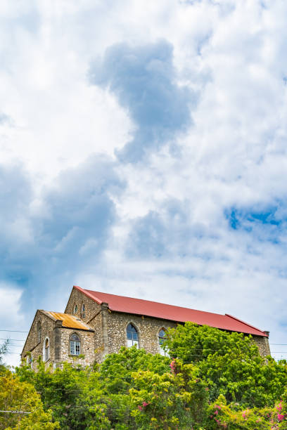 Small modest old stone wall, red zinc roof, stained glass window chapel on rural countryside hill. Small modest old stone wall, red zinc roof, stained glass window chapel on rural countryside hill. Rio Bueno Baptist Church in Trelawny parish, Jamaica. Christianity is a dominant Caribbean religion. 1901 stock pictures, royalty-free photos & images