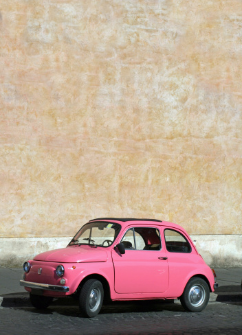 Tiny pink vintage car in Rome, Italy