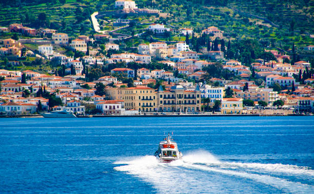 Small red motor boat transfer people to Spetses island, Greece stock photo