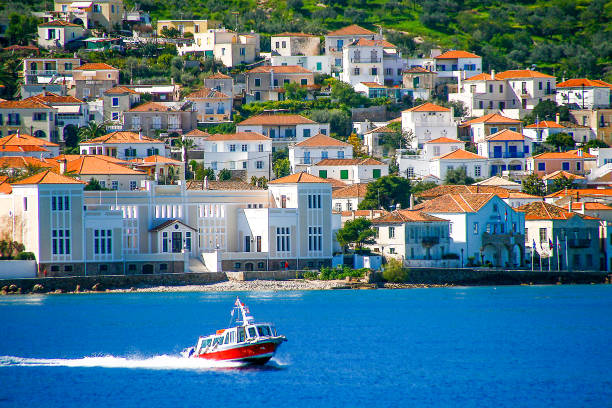 Small red motor boat transfer people to Spetses island, Greece. stock photo