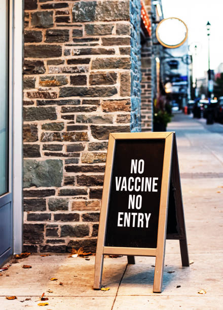 Small Shop Requires Vaccination A small shop requires the Covid-19 vaccination for entry. anti vaccination stock pictures, royalty-free photos & images