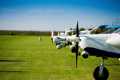 Small sports airplanes in a row on field