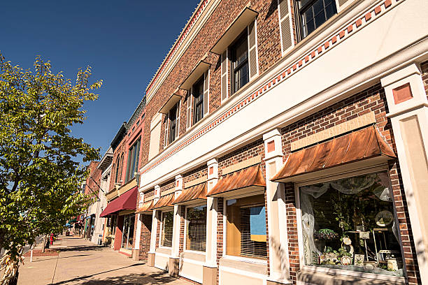 Small Town Main Street A photo of a typical small town main street in the United States of America. Features old brick buildings with specialty shops and restaurants. small town stock pictures, royalty-free photos & images