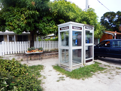 Telephone booths.  Fruit for sale.