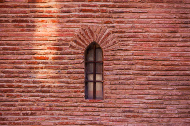 Small window on the medieval wall stock photo