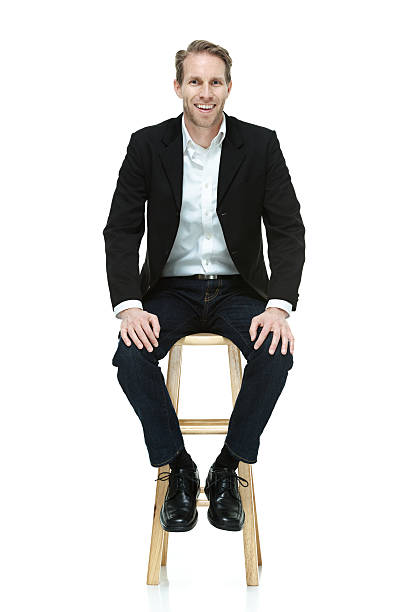 Smart casual man on stool Smart casual man on stoolhttp://www.twodozendesign.info/i/1.png stool stock pictures, royalty-free photos & images