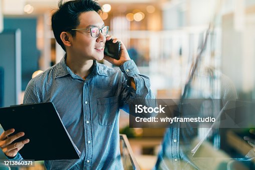 istock smart confidence asian startup entrepreneur business owner businessman smile hand use smartphone woking in office background 1213860371