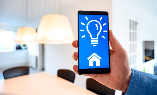 Smart home automation with app on smart phone to control light stock photo