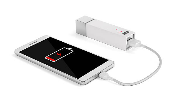 Smartphone charging with external battery Smartphone charging with power bank on white background battery charger stock pictures, royalty-free photos & images
