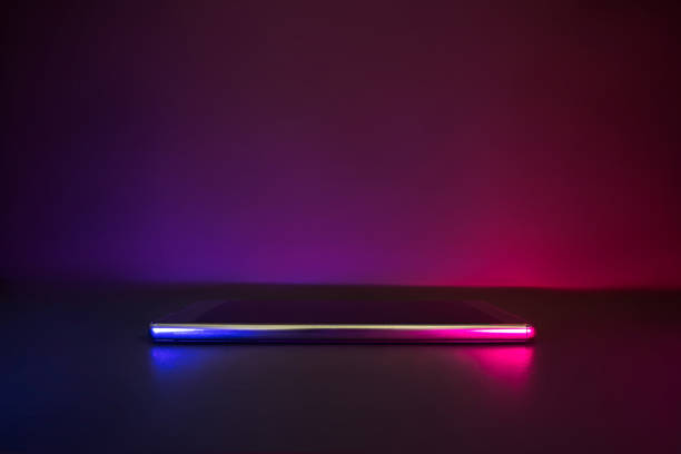 Smartphone with neon blue and pink light copy space. stock photo