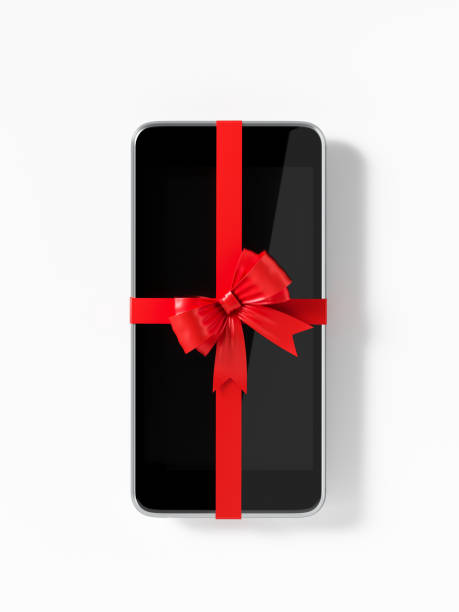 smartphone with red bow tie on white background - smartphone christmas imagens e fotografias de stock