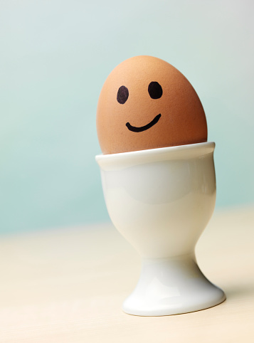 Smiley Face On A Boiled Egg In An Egg Cup Stock Photo - Download Image Now - iStock