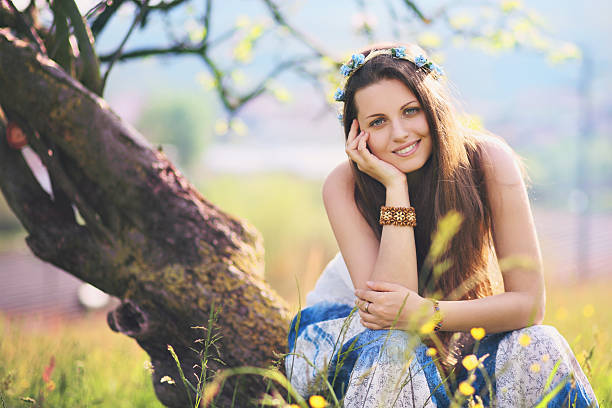Smiling and joyful woman in spring meadow stock photo