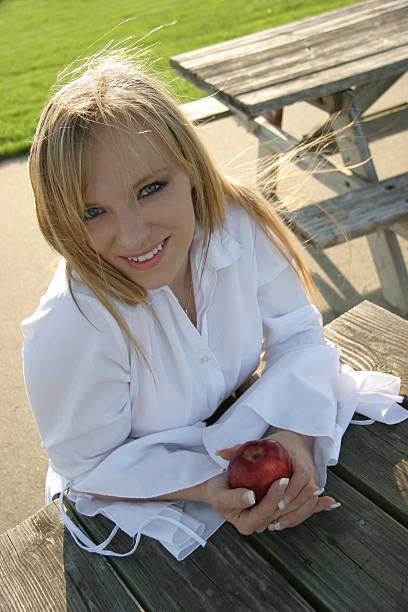 Smiling Blonde with Apple stock photo