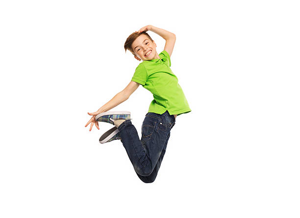 smiling boy jumping in air happiness, childhood, freedom, movement and people concept - smiling boy jumping in air boy jumping stock pictures, royalty-free photos & images