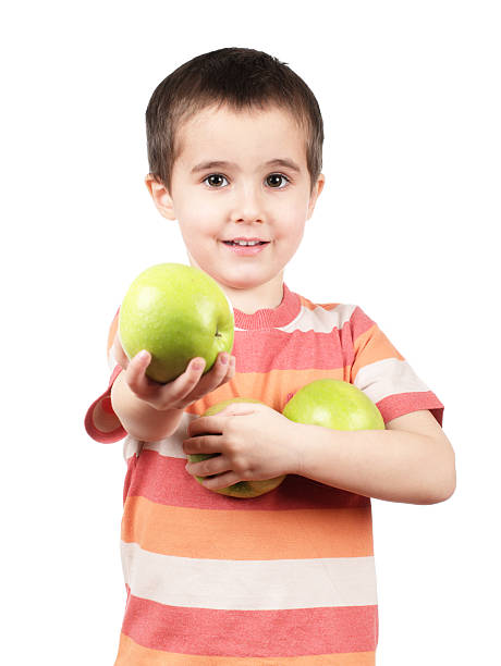 Smiling boy offers apple stock photo