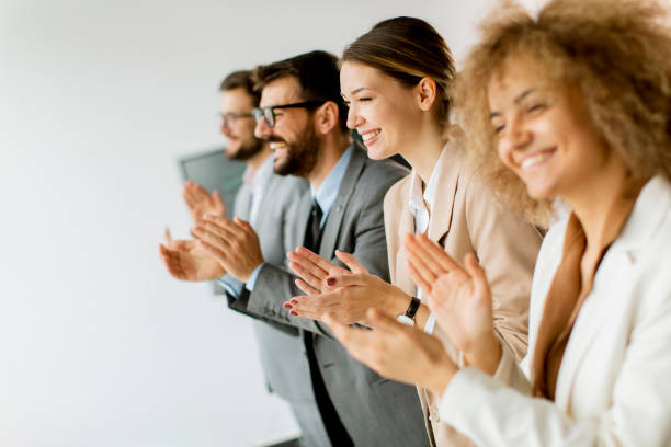 Smiling business group clapping hands after the meeting stock photo