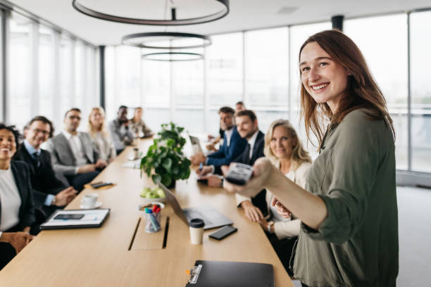 Smiling business woman leading a meeting stock photo