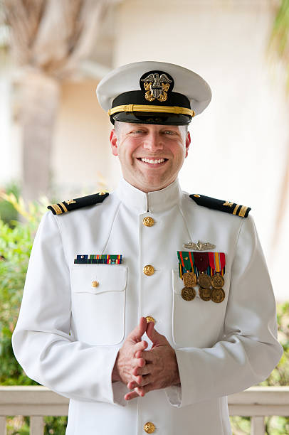 Smiling Caucasian Naval Officer in Winter Whites Uniform Smiling Naval Officer military uniform stock pictures, royalty-free photos & images